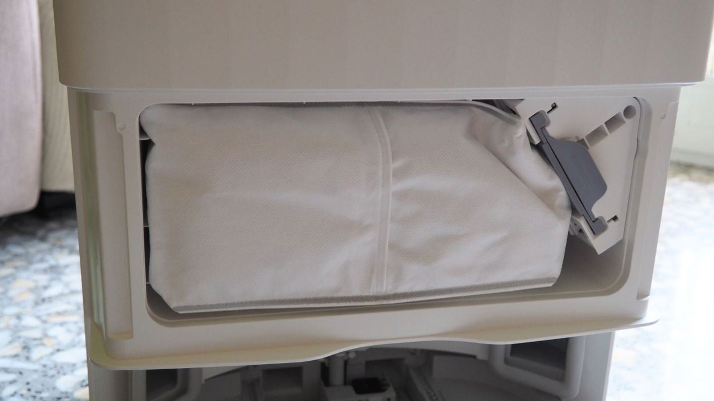 En la parte delantera de la estación multifunción todo en uno, oculta tras una tapadera, se encuentra la bolsa desechable para el polvo. El agua sucia se deposita en otro contenedor, ubicado en la parte superior de la base | Imagen de Jesús Quesada