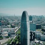 videoblocks barcelona spain april 15 2017 famous torre agbar skyscraper city and sea aerial view on a sunny day 4k establishing shot rwa75zvce thumbnail full01_643x397