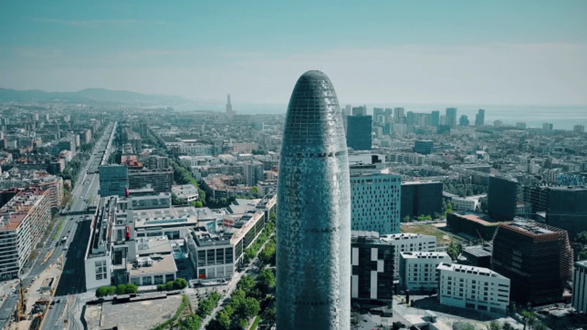 videoblocks barcelona spain april 15 2017 famous torre agbar skyscraper city and sea aerial view on a sunny day 4k establishing shot rwa75zvce thumbnail full01_643x397