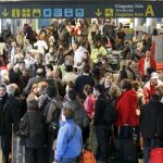Centenares de personas esperan información de sus vuelos, en el aeropuerto de Lvacolla, donde se han cancelado varios vuelos y desviado otros a causa del conflicto de los controladores aéreos, esta mañana en Santiago de Compostela