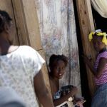 Mujeres a la entrada de una de las casas construidas por la ONG Mensajeros de la Paz en Puerto Prícipe