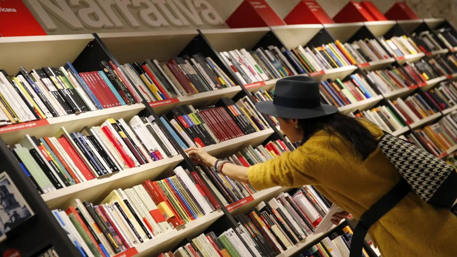 Una mujer mira libros hoy en una librería en Madrid.