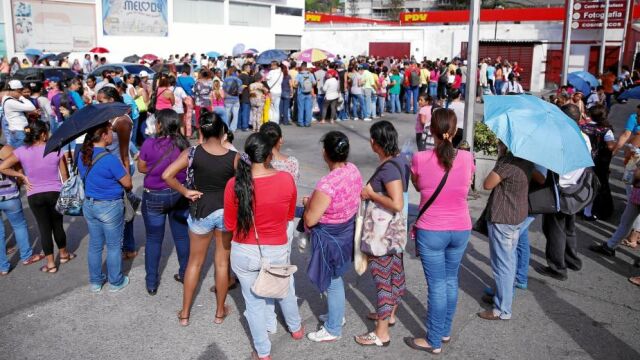 Decenas de venezolanos hacen cola para conseguir productos de primera necesidad en un barrio de Caracas