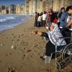 Un grupo de personas lanza flores al mar durante un homenaje a las víctimas del avión de Egyptair en Alejandría