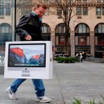 La tecnología, uno de los puntos fuertes del «Black Friday». En la imagen, un hombre con un ordenador Apple que acaba de comprar en la semana de descuentos de 2016 / Reuters