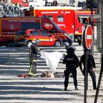Un bombero cubre el cuerpo del hombre