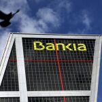 A dove flies near the headquarters of Spanish nationalised lender Bankia in Madrid, Spain, February 17, 2016. REUTERS/Susana Vera