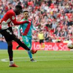 El jugador del Athletic de Bilbao, Iñaki Williams (i), en el momento de marcar el primer gol, ante dos jugadores del Rayo Vallecano