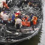 Miembros de los Servicios de Rescate indonesios recuperan los cadáveres de las víctimas de un incendio en una embarcación en el puerto Muara Angke de Yakarta, Indonesia.