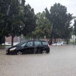 Un vehículo en medio de la intensa lluvia caída esta mañana en la pedanía murciana de la Alberca (Murcia), que ha obligado a cortar distintos viales del municipio de Murcia