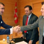 El consejero Suárez-Quiñones saluda a los procuradores socialistas Celestino Rodríguez y José Luis Aceves, antes de comparecer en las Cortes