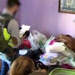 Dos agentes analizan la documentación encontrada durante uno de los registros