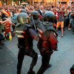 Varios agentes de Policía, rodeados por manifestantes durante el registro de la sede de la CUP el 20 de septiembre de 2017. Foto: REUTERS