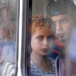 Un joven rescatado el viernes del naufragio de la barcaza con más de 250 inmigrantes a bordo mira desde el autobús policial, ayer en el puerto de Valeta, Malta