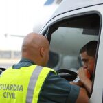 Un guardia civil realiza un test de alcoholemia a un conductor