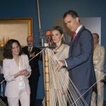 Los Príncipes de Asturias, junto a la comisaria de la muestra, Carmen Marcos (i), observan una maqueta durante la inauguración de la exposición "El último viaje de la fragata Nuestra Señora de las Mercedes", en el Museo Arqueológico Nacional.
