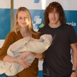 Vanessa Lorenzo y Carles Puyol, con la pequeña Manuela a la salida del hospital.