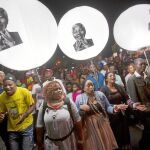 TRIBUTO GLOBAL. Varios ciudadanos marchan frente la casa de Mandela en Soweto, Johannesburgo