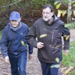 El presidente del Gobierno, Mariano Rajoy (d), que se ha desplazado a las Rías Baixas (Pontevedra) donde pasará unos días de descanso junto a su familia, ha caminado hoy por la ruta que lleva al monasterio de Armenteira, acompañado de José Benito Suárez (i), marido de la ministra de Fomento Ana Pastor.