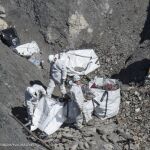 Los servicios de emergencias recogen los restos del avión y descontaminan la zona