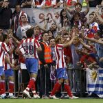 El delantero uruguayo del Atlético de Madrid, Diego Forlán (c), celebra su gol, primero de su equipo, con la afición, durante el partido