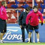 Alves observa a Messi durante el entrenamiento de ayer