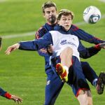 Fernando Llorente intenta controlar una pelota ante el acoso de Piqué