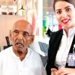 Swami Sivananda, junto a una azafata en aeropuerto de Abu Dhabi.