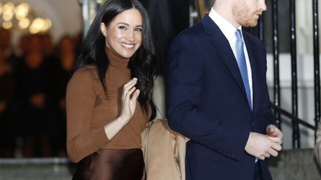 FILE - In this Tuesday, Jan. 7, 2020 file photo, Britain's Prince Harry and Meghan, Duchess of Sussex smile as they leave Canada House, in London. Prince Harry and his wife Meghan 'stepping back' as senior UK royals, will work to become financially independent, they announced Wednesday, Jan. 8, 2020.(Daniel Leal-Olivas/Pool Photo via AP, file)