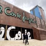 Dos personas pasan junto a unas letras de El Corte Inglés en el edificio de estos almacenes de Nuevos Ministerios, en Madrid