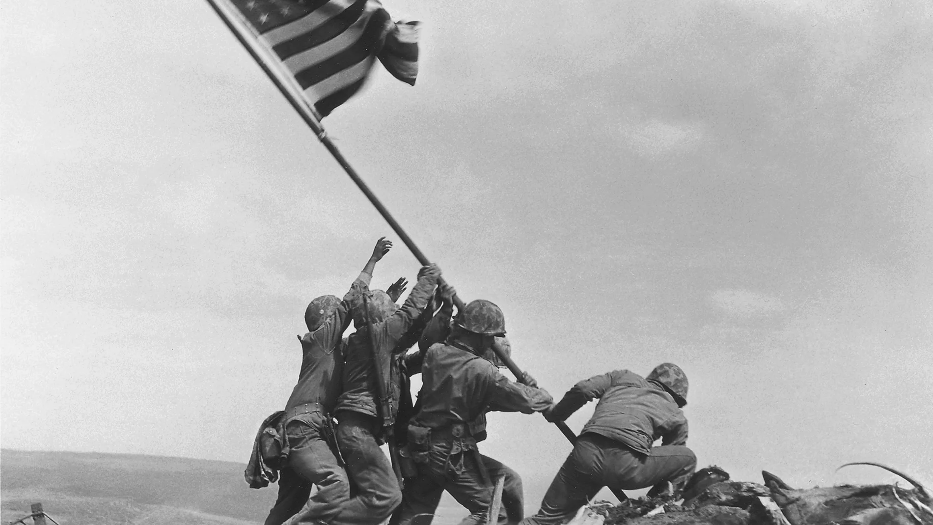 FILE - In this June 4, 1945 file photo, President Harry Truman, left, is presented with a bronze statue by sculptor Felix de Weldon, center, and Associated Press photographer Joe Rosenthal at the White House in Washington. The sculpture, depicting five Marines and a Navy Corpsman raising the flag on the island of Iwo Jima, was inspired by a photo taken by Rosenthal, Feb. 23, 1945. The sculpture was scaled up by de Weldon to the towering Marine Corps War Memorial erected in 1954 in Arlington, Va. The scaled-up version, which is the original piece, is to be auctioned at Bonhams auction house on Feb. 22, 2013, a day before the 68th anniversary of the historic event. (AP Photo/File)
