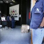 Agentes de la Agencia Tributaria en la puerta de una de las naves con productos procedentes de China registradas en el polígono de El Carrús (Elche) donde se leva hoy a cabo una operación nacional contra la economía sumergida y el fraude fiscal en importaciones, distribución y venta de productos procedentes de China con el registro de 61 naves en polígonos de 11 comunidades autónomas e inspecciones a 66 sociedades. EFE/Manuel Lorenzo