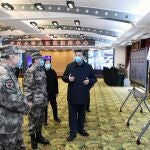 In this photo released by China's Xinhua News Agency, Chinese President Xi Jinping, right, is briefed about the Huoshenshan Hospital in Wuhan in central China's Hubei Province, Tuesday, March 10, 2020. China's president visited the center of the global virus outbreak Tuesday as Italy began a sweeping nationwide travel ban and people worldwide braced for the possibility of recession. For most people, the new coronavirus causes only mild or moderate symptoms, such as fever and cough. For some, especially older adults and people with existing health problems, it can cause more severe illness, including pneumonia. (Xie Huanchi/Xinhua via AP)