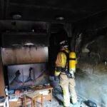 Los bomberos en una vivienda incendiada