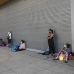 Wearing masks against the spread of the new coronavirus, people wait outside a public hospital, in Lima, Peru, Tuesday, May 12, 2020. The line of those waiting is of both patients and relatives of patients. (AP Photo/Rodrigo Abd)