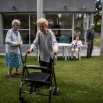 Algunos residentes de «El Madroño», en Galapagar, pasean por el jardín de la residencia