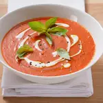 Plato de gazpacho con crema y albahaca