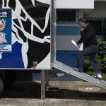 A deportee enters a mobile health clinic at the Immigration Institute shelter where Guatemalans deported from the U.S. are being held in quarantine, during a press tour in Guatemala City, Tuesday, July 7, 2020. According to the institute, more than 3,000 Guatemalans have been deported from the United States and 134 have tested positive for COVID-19 since the onset of the coronavirus emergency. (AP Photo/Moises Castillo)