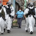 Soldiers in protective gear amid the COVID-19 pandemic patrol in Ciudad Bolivar, an area with high cases of the new coronavirus in Bogota, Colombia, Monday, July 13, 2020. The mayor of Bogota ordered tight restrictions in areas seeing the highest contagion. (AP Photo/Fernando Vergara)