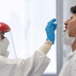 Una sanitaria del 061 toma muestras de PCR a un hombre en el centro de salud sur de Totana