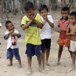 FILE - In this Sept. 10, 2015 file photo, Wayuu children play in Manaure, Colombia. A human rights group released a report Thursday, Aug. 13, 2020, warning that lack of access to clean water is leading to alarmingly high levels of child mortality and malnutrition among the Wayuu, Colombiaâ€™s largest Indigenous group. (AP Photo/Fernando Vergara, File)