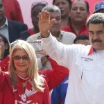 FILE - In this May 20, 2109 file photo, Venezuela's President Nicolas Maduro and his wife Cilia Flores wave to supporters outside Miraflores presidential palace in Caracas, Venezuela. A nephew of Venezuelaâ€™s first lady appealed on Tuesday, Aug. 25, 2020, to the U.S. Supreme Court an 18-year sentence for conspiring to smuggle 800 kilograms of cocaine into the U.S. (AP Photo/Ariana Cubillos, File)
