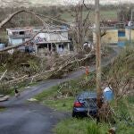 FILE - In this Sept. 26, 2017 file photo, Jonathan Aponte walks with a gas can up the road to his home in the aftermath of Hurricane Maria, in Yabucoa, Puerto Rico, Tuesday, Sept. 26, 2017. Puerto Rico is getting much of the money it needs to rebuild its power grid three years after it was wiped out by Hurricane Maria, the island territory's governor and the White House said Friday. (AP Photo/Gerald Herbert)