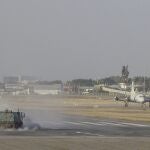 A street sweeper truck clears volcanic ash from the runway of the Jose Joaquin de Olmedo international airport in Guayaquil, Ecuador, Sunday, Sept. 20, 2020. An intense volcanic ash fall was registered in various parts of Ecuador due to an eruption of Sangay Volcano, located in the Amazon area of the country. (AP Photo/Angel Dejesus)