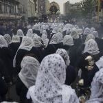 FILE - in this Oct. 18, 2019 file photo, faithful take part in a procession honoring The Lord of Miracles, the patron saint of Lima, Peru. The 2020 procession of The Lord of Miracles has been canceled as a measure to curb the spread of the new coronavirus. (AP Photo/Rodrigo Abd, File)