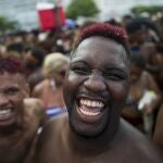 FILE - in this Jan. 12, 2020 file photo, revelers smile as they look on the camera during the "Bloco da Favorita" street party on Copacabana beach, Rio de Janeiro, Brazil. The city announced on Thursday, Sept. 24, said it has delayed its annual Carnival parade, saying the global spectacle cannot go ahead in February because of Brazilâ€™s continued vulnerability to the new coronavirus pandemic, but has yet to announce a decision about the Carnival street parties that take place across the city. (AP Photo/Bruna Prado, File)