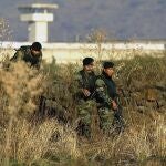 FILE - In this Jan. 28, 2005 file photo, Mexican Army soldiers inspect the surrounding the top-security Puente Grande prison, on the outskirts Guadalajara City, Mexico. The Mexican government announced Monday, Sept. 28, 2020, that it will close the Puente Grande federal prison made famous by the 2001 escape of convicted drug lord Joaquin "El Chapo" Guzman. (AP Photo/Guillermo Arias, File)