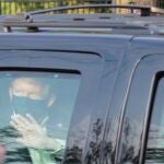 President Donald Trump drives past supporters gathered outside Walter Reed National Military Medical Center in Bethesda, Md., Sunday, Oct. 4, 2020. Trump was admitted to the hospital after contracting COVID-19. (AP Photo/