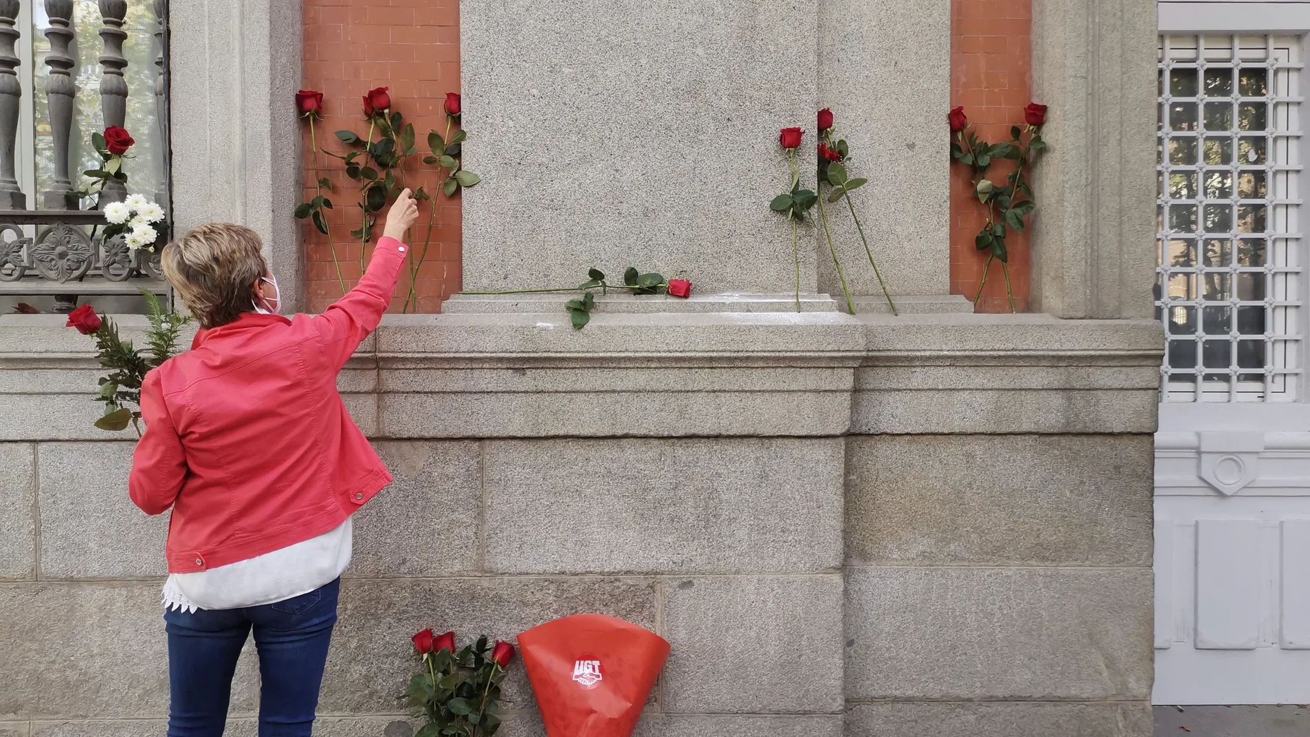 GRAF1150. MADRID, 15/10/2020.- Una mujer deposita flores en el lugar en el que se encontraba la placa colocada en honor de Francisco Largo Caballero. Más Madrid y PSOE han denunciado este jueves la retirada de la placa colocada en honor de Francisco Largo Caballero, presidente de la II República, en el distrito madrileño de Chamberí, y censuran al Gobierno municipal por no informar a los grupos de esta actuación. EFE/ María José Cardenete