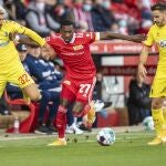 Sheraldo Becker, del Union Berlín, intenta llevarse la pelota entre dos jugadores del Friburgo